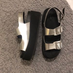 Silver platform sandals.
